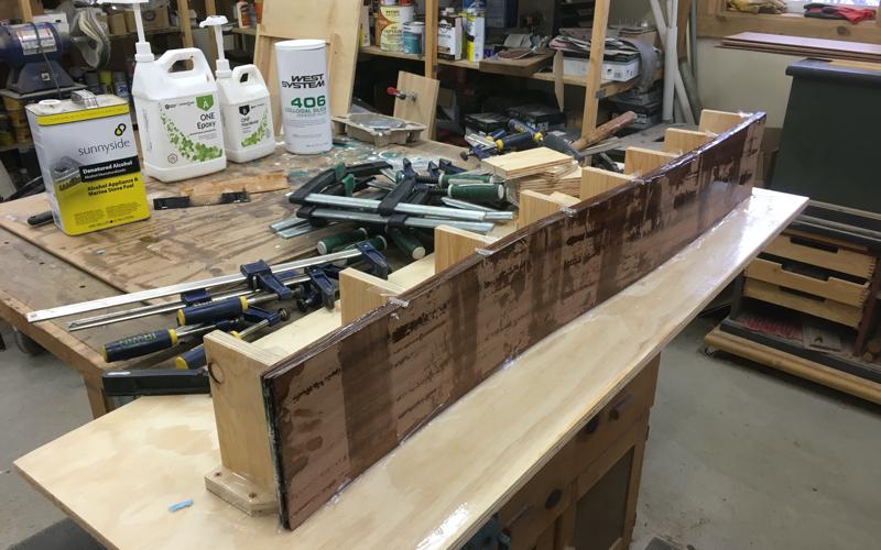 New mahogany covering board laminated to shape of sheerline.